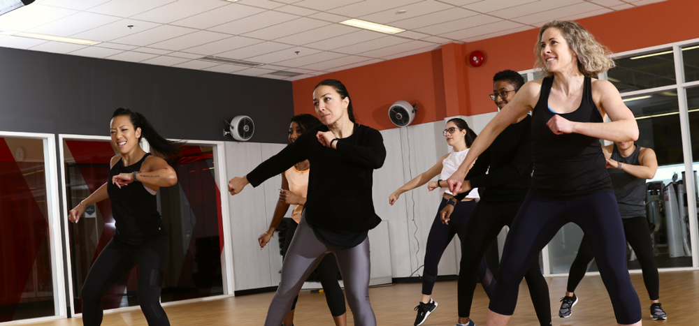 Seven people participating in a group fitness class