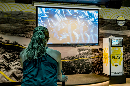 Person selecting a workout category on a touchscreen