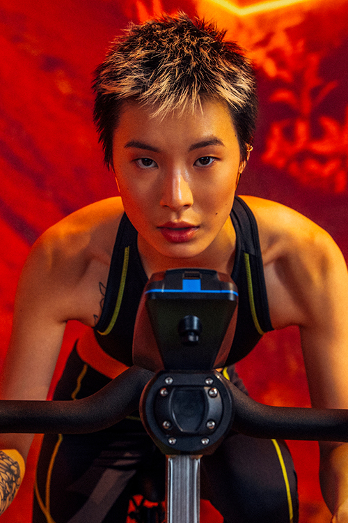 Woman pushing sled with weights on it.