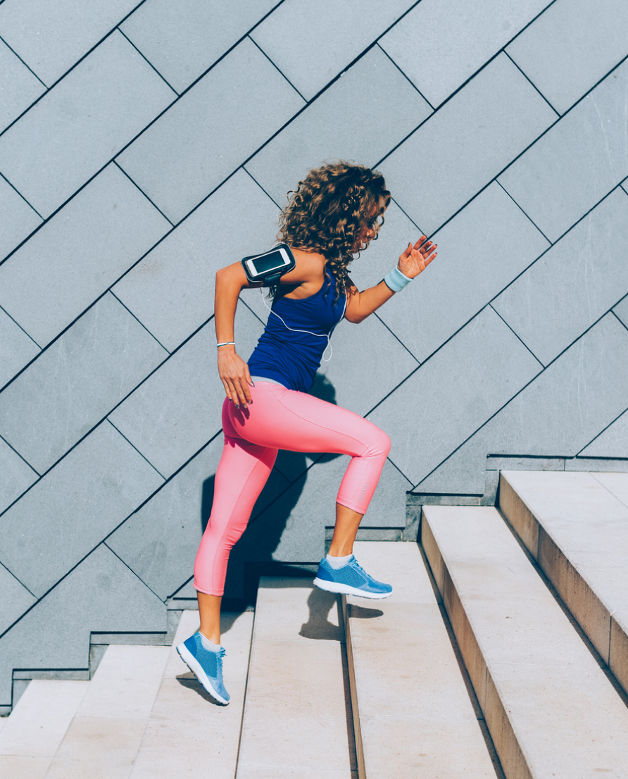 Woman running up stairs outdoors