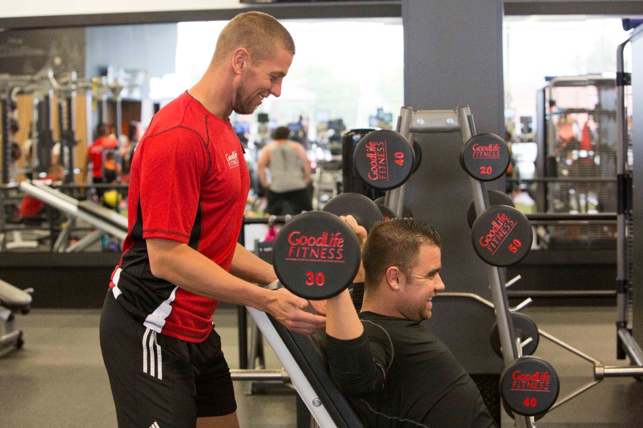 Personal trainer shakes.a client’s hand 