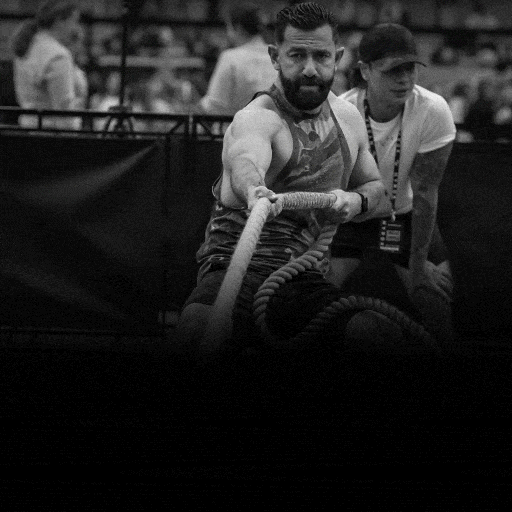 A dynamic image of two HYROX Training Club participants during an activity.