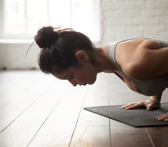 Closeup of a woman planking on a yoga mat