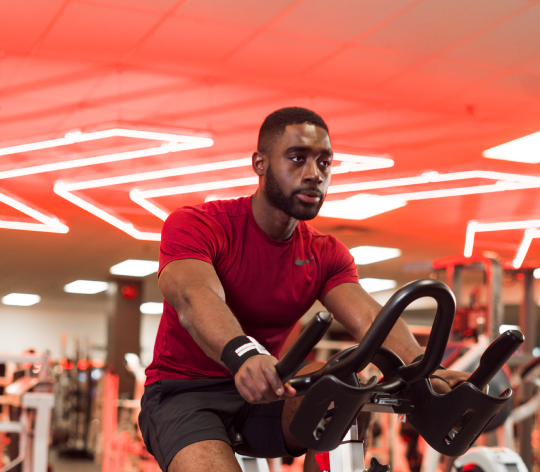 Man cycling in a GoodLife club